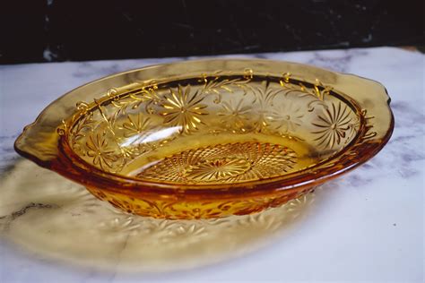 Amber depression glass bowl - Sharon was produced in amber, pink, and green. Amber, called "Golden Glow" in the original catalogs, is the most plentiful color; pink, or "Rose Glow" is the most sought after color, and "Springtime Green" is the hardest color to find. There are also three pieces available in crystal: the cake plate, footed tumbler, and 7½ inch plate.